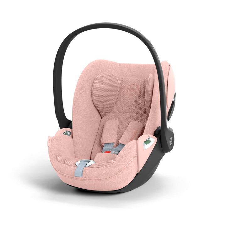 Cybex Cloud T i-Size baby-autostoel in peach pink, getoond in liggende positie met ISOFIX basis.