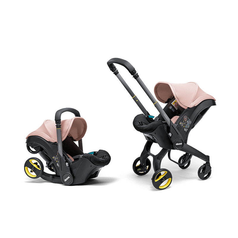 Doona i autostoel in Blush Pink, transformeert van autostoel naar vervoersmiddel met wielen, voldoet aan i-Size normen.
