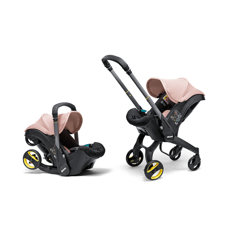 Doona i autostoel in Blush Pink, transformeert van autostoel naar vervoersmiddel met wielen, voldoet aan i-Size normen.
