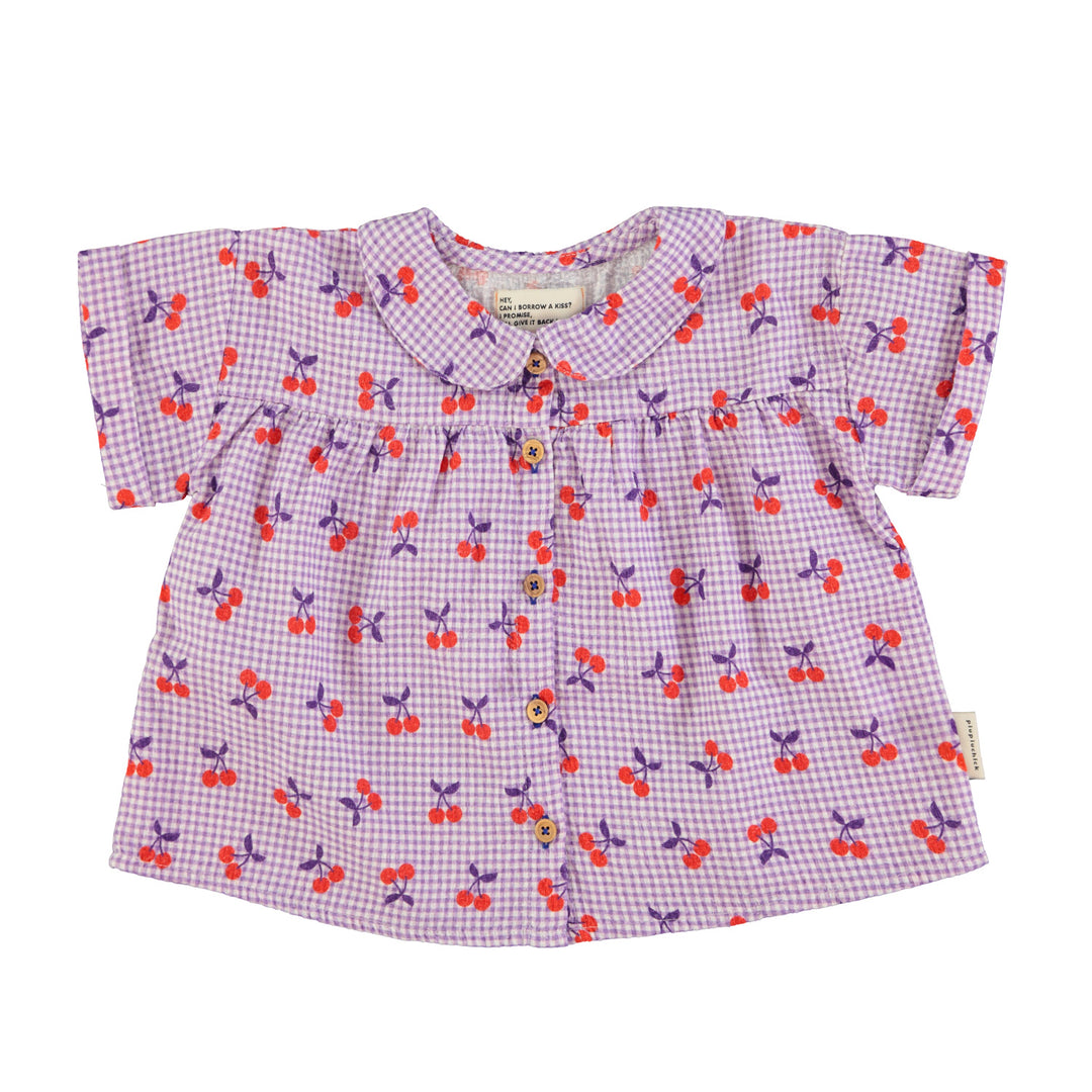 Paarse blouse van Piupiuchick met kersenprint, ruitjes en houten knopen