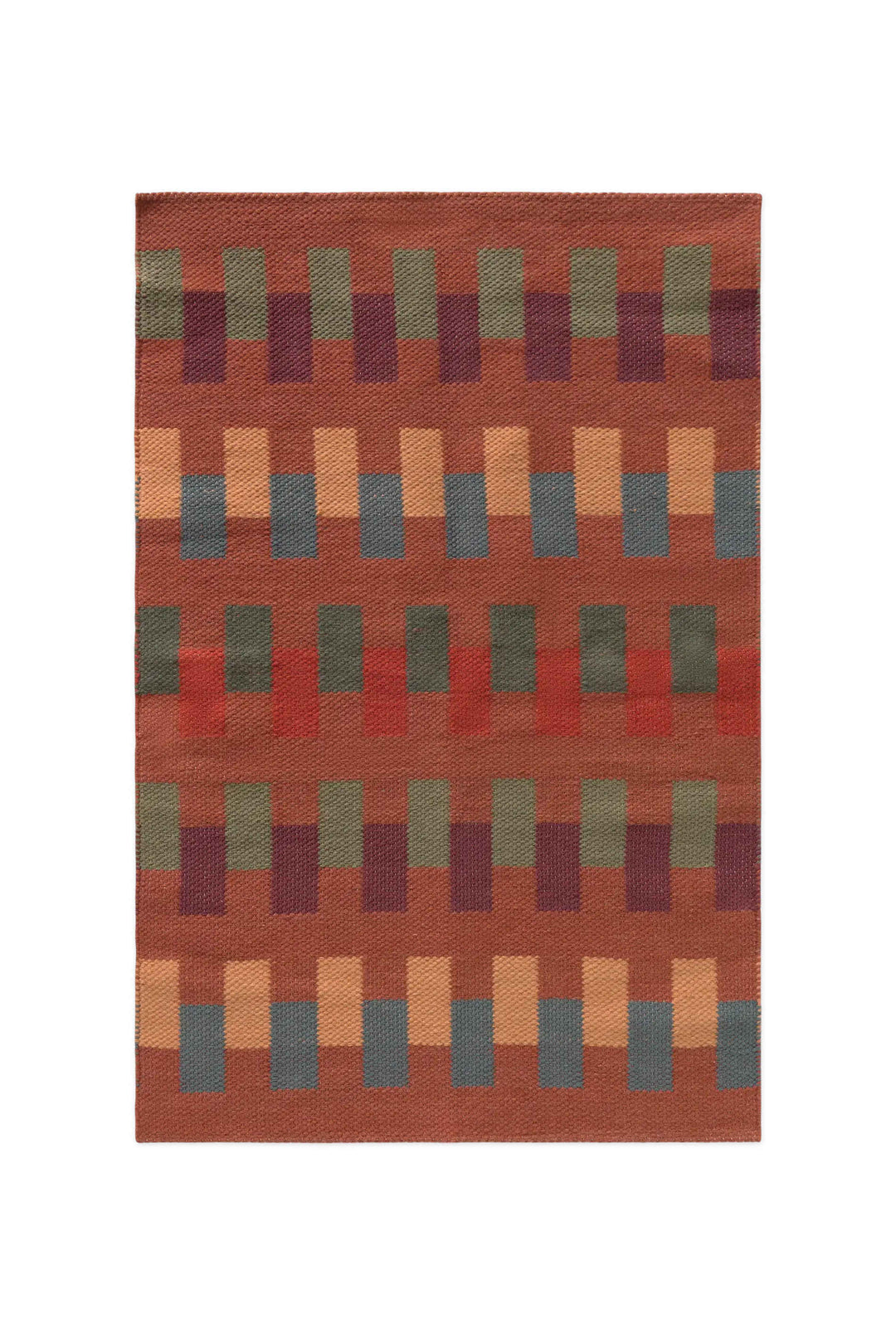 Lorena Canals Intersecting tapijt Sienna 86x130 cm met geometrische vlakken in groen, blauw, oker en bordeaux.