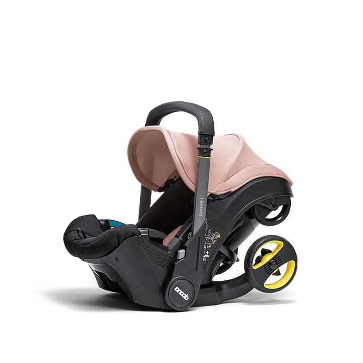 Doona i autostoel in Blush Pink, transformeert van autostoel naar vervoersmiddel met wielen, voldoet aan i-Size normen.