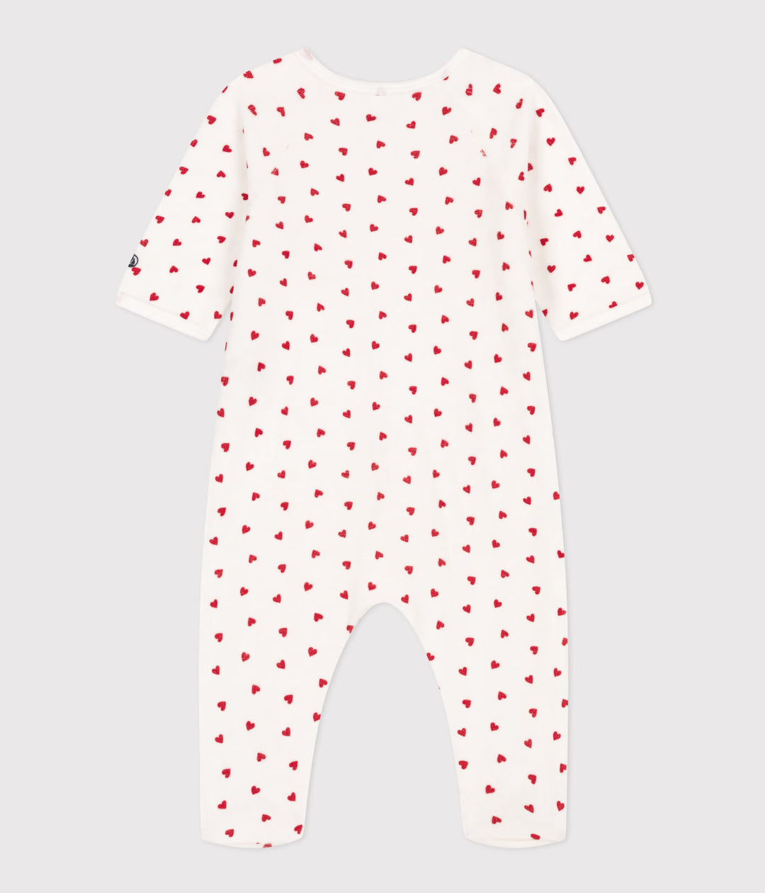 Petit Bateau baby pyjama met rode hartjes en zijsgewijze sluiting