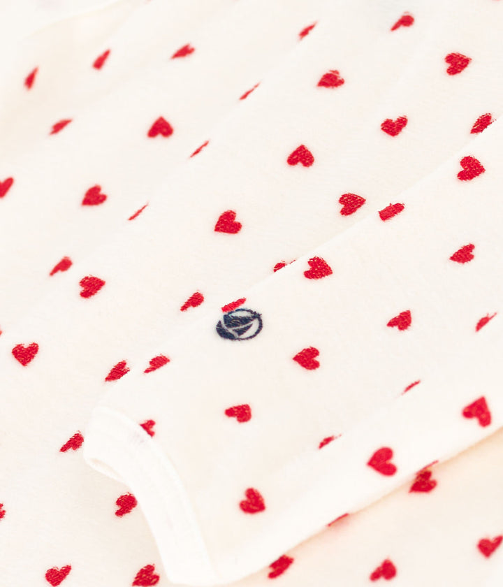 Petit Bateau baby pyjama met rode hartjes en zijsgewijze sluiting