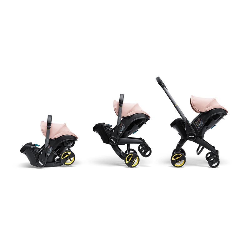 Doona i autostoel in Blush Pink, transformeert van autostoel naar vervoersmiddel met wielen, voldoet aan i-Size normen.