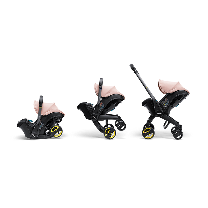 Doona i autostoel in Blush Pink, transformeert van autostoel naar vervoersmiddel met wielen, voldoet aan i-Size normen.