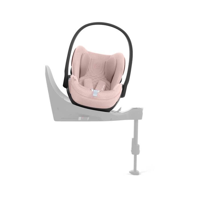 Cybex Cloud T i-Size baby-autostoel in peach pink, getoond in liggende positie met ISOFIX basis.